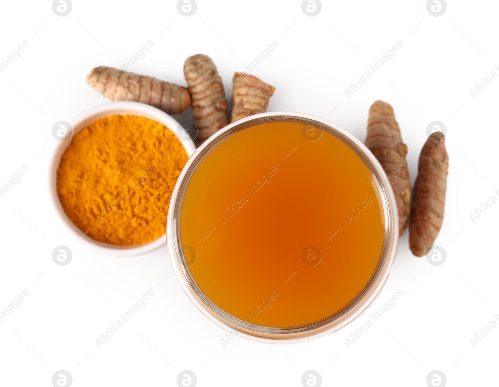 Photo of Aromatic turmeric tea in glass, roots and powder isolated on white, top view