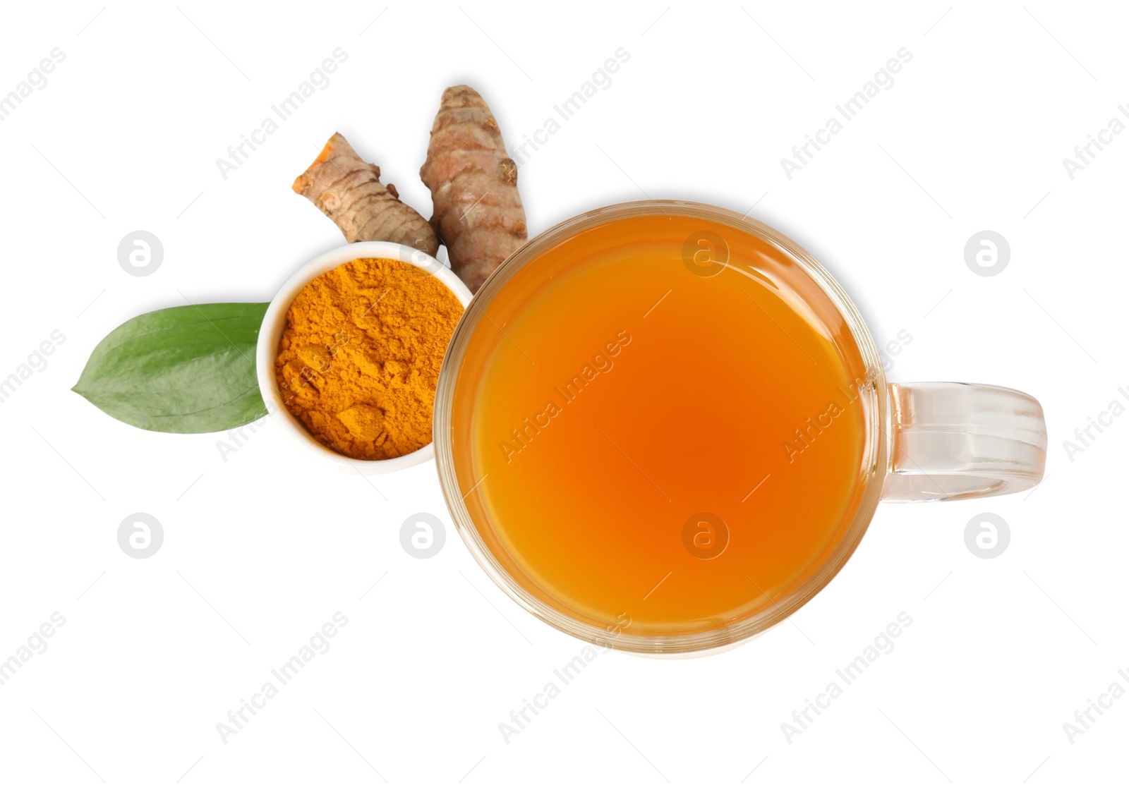 Photo of Aromatic turmeric tea in glass cup, roots, powder and green leaf isolated on white, top view