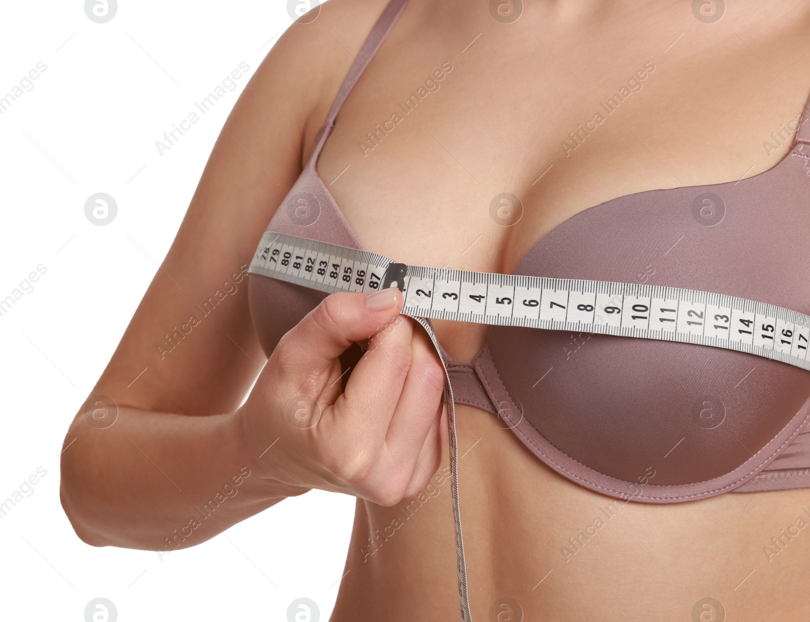 Photo of Woman in beautiful bra measuring breast circumference on white background, closeup