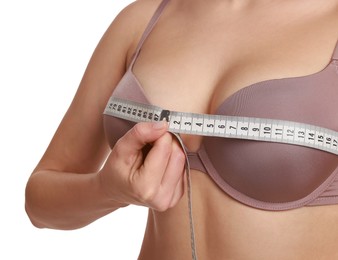 Photo of Woman in beautiful bra measuring breast circumference on white background, closeup