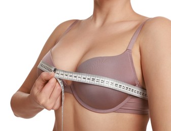 Photo of Woman in beautiful bra measuring breast circumference on white background, closeup