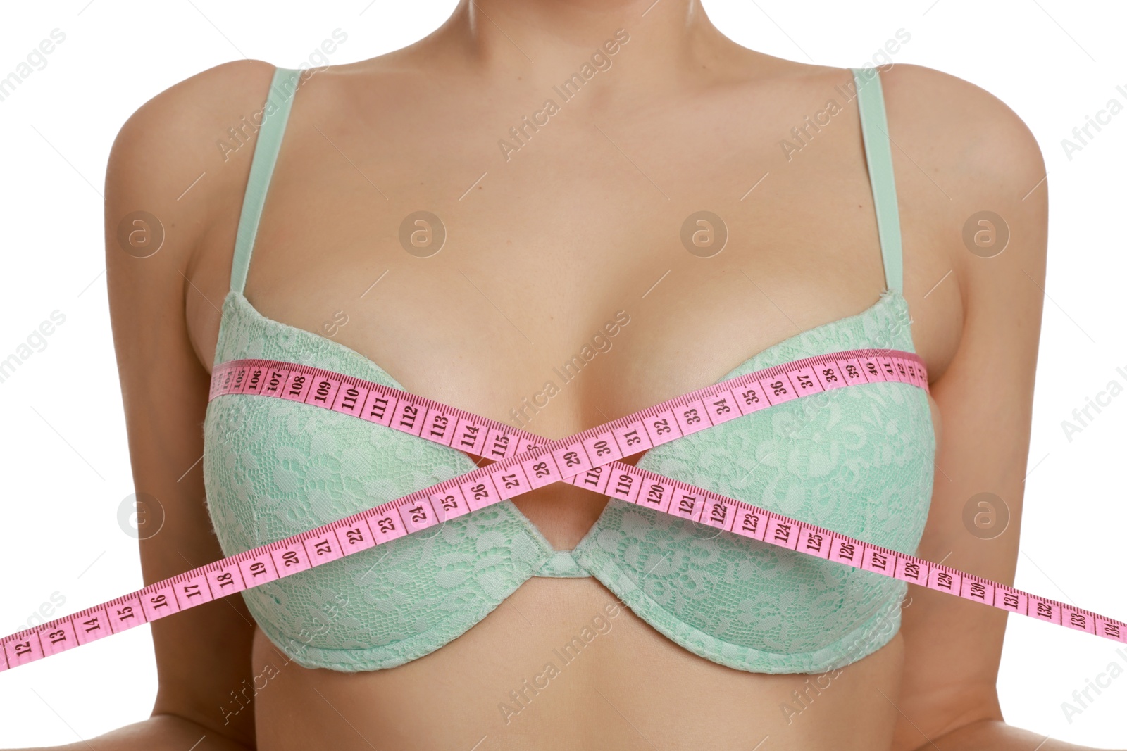 Photo of Woman in beautiful bra measuring breast circumference on white background, closeup