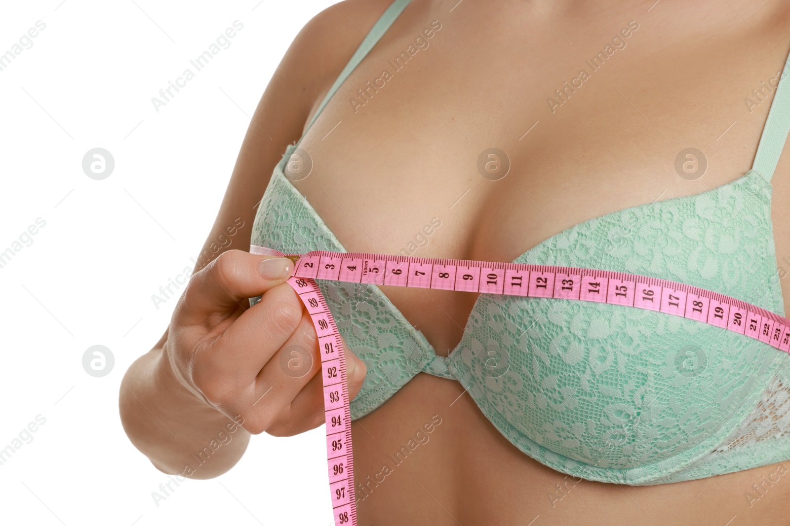 Photo of Woman in beautiful bra measuring breast circumference on white background, closeup