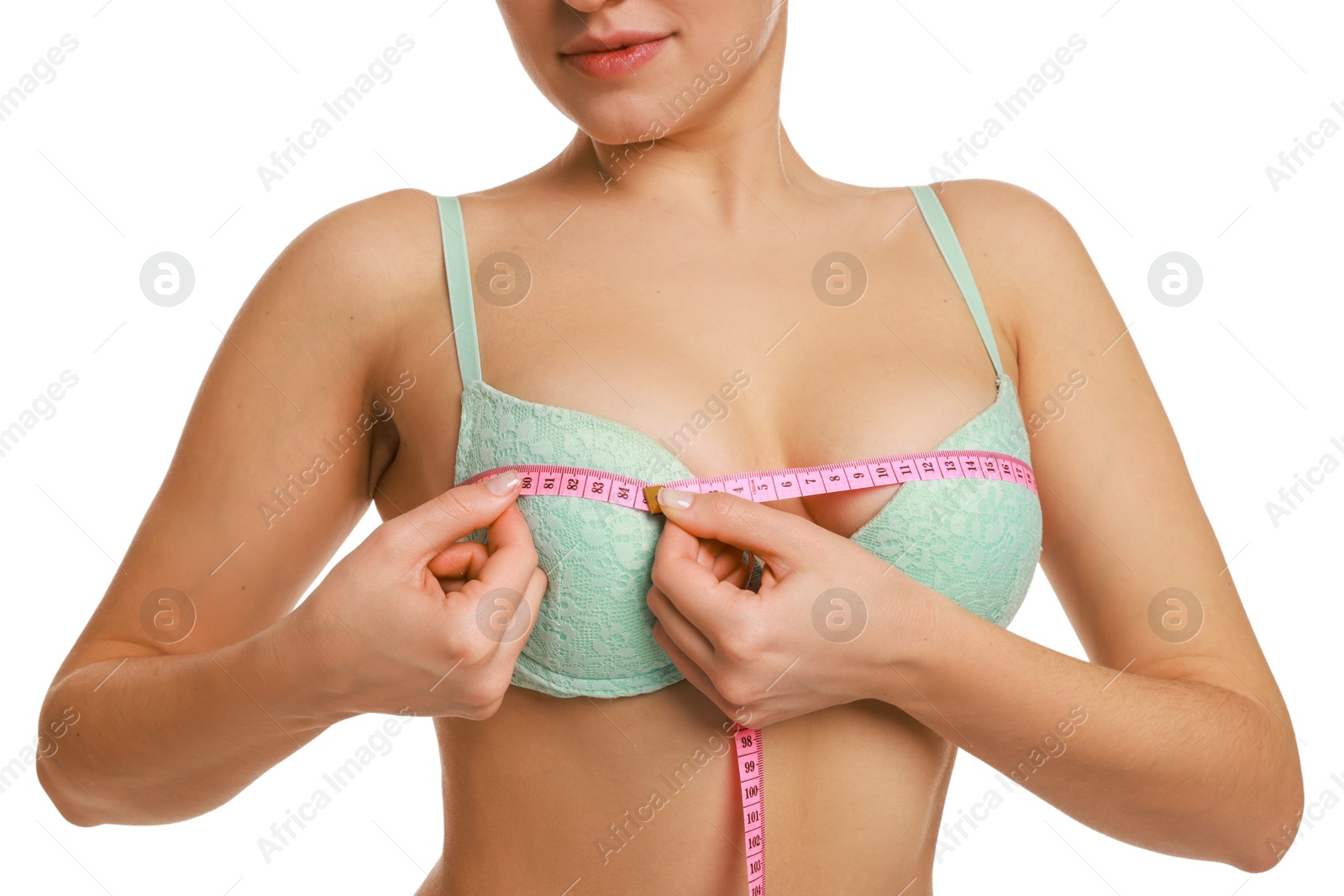 Photo of Woman in beautiful bra measuring breast circumference on white background, closeup