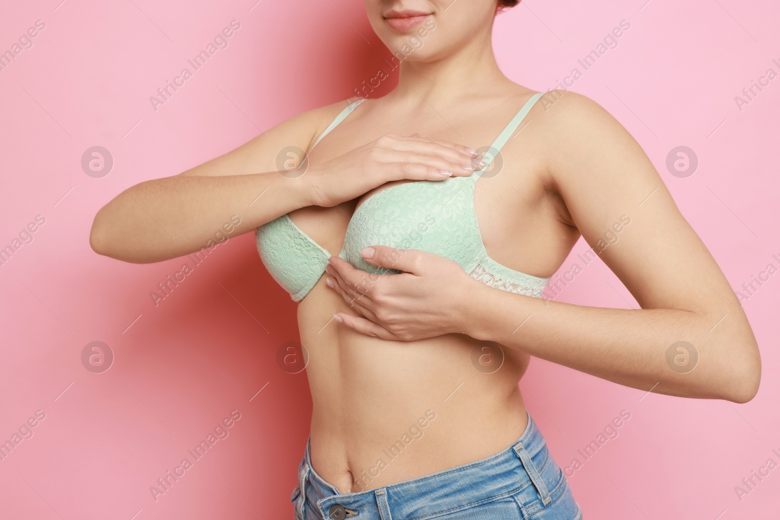 Photo of Woman wearing beautiful bra on pink background, closeup