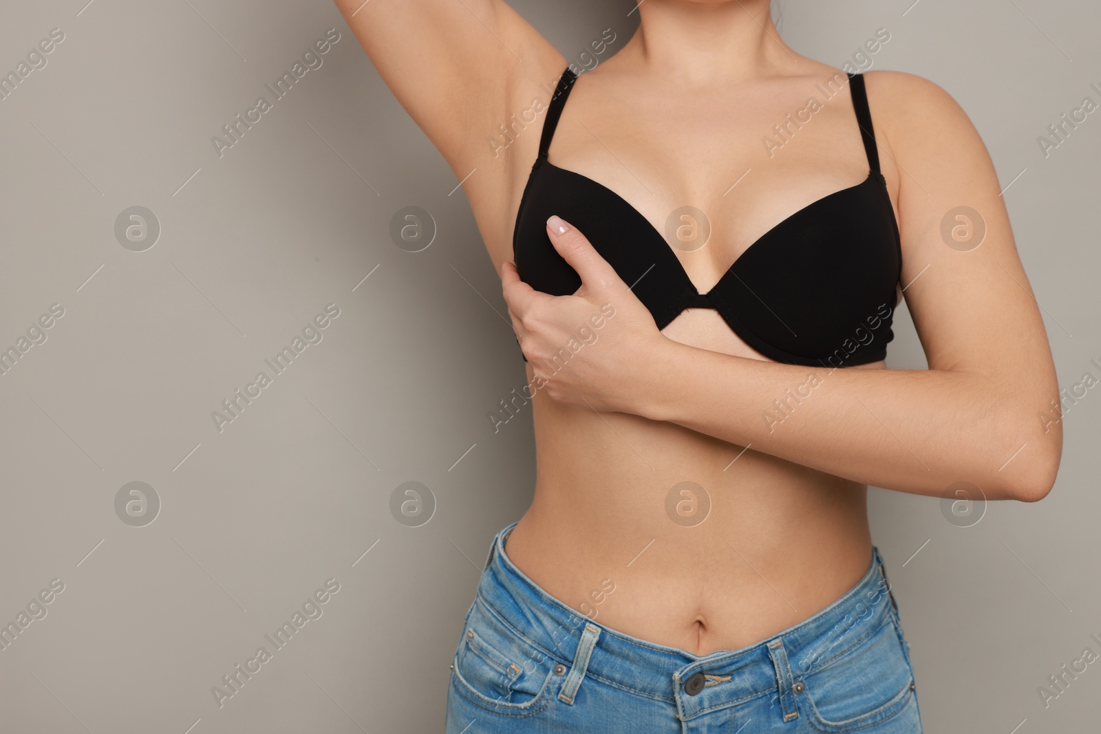 Photo of Woman wearing beautiful bra on light background, closeup. Space for text