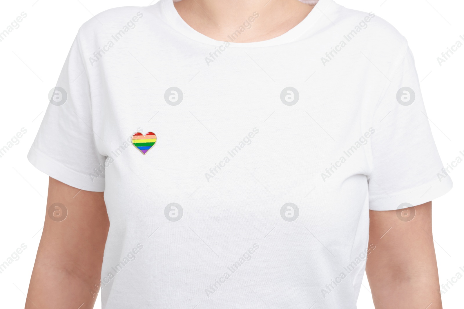 Photo of Woman with heart shaped pin in LGBT colors on white background, closeup