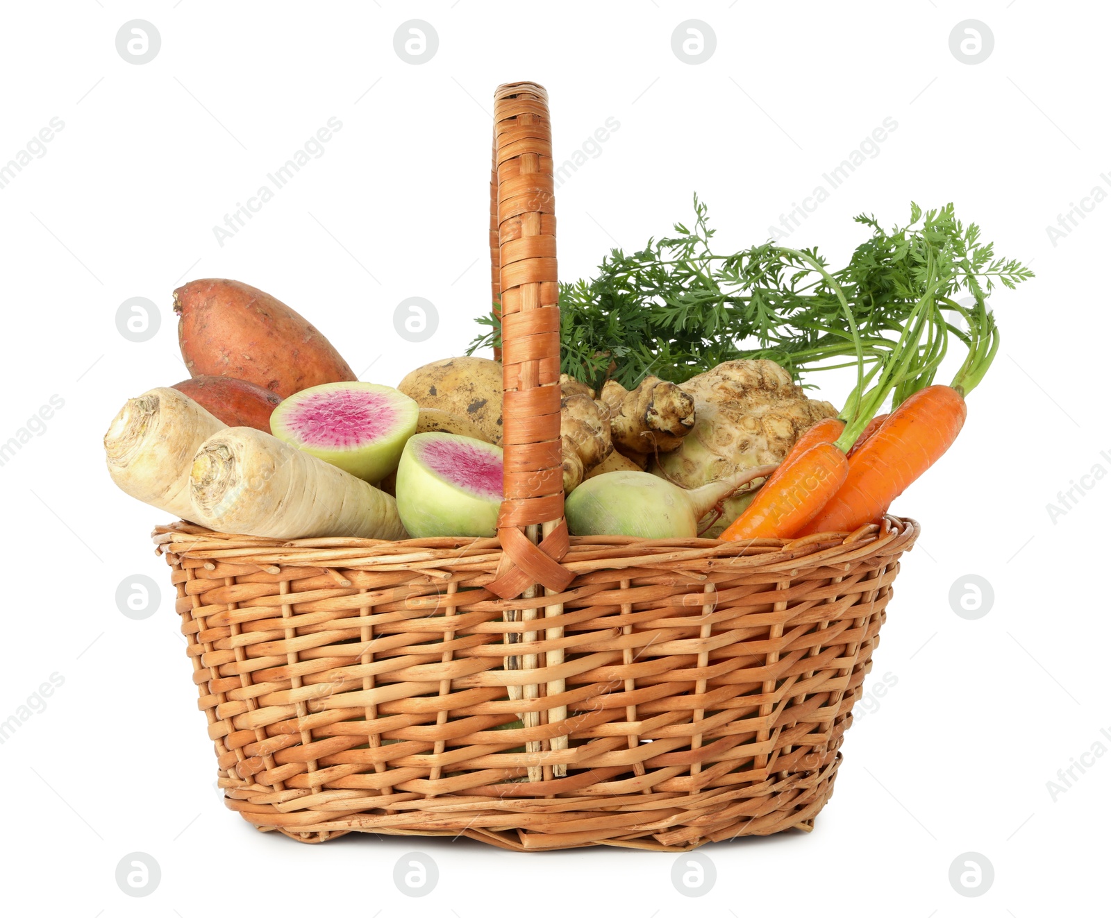 Photo of Different root vegetables in wicker basket isolated on white