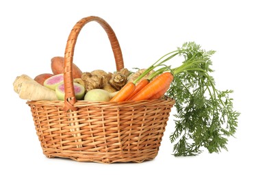 Photo of Different root vegetables in wicker basket isolated on white