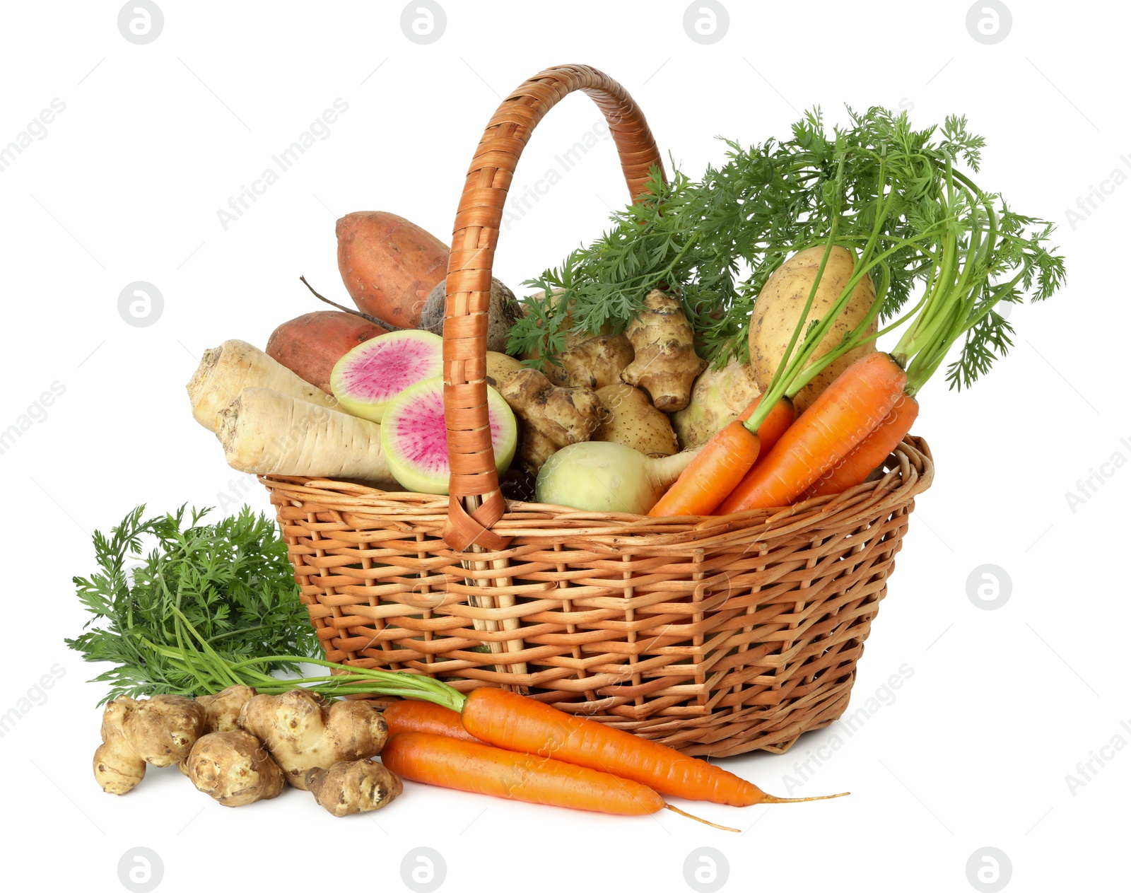 Photo of Different root vegetables in wicker basket isolated on white