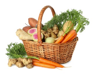 Photo of Different root vegetables in wicker basket isolated on white