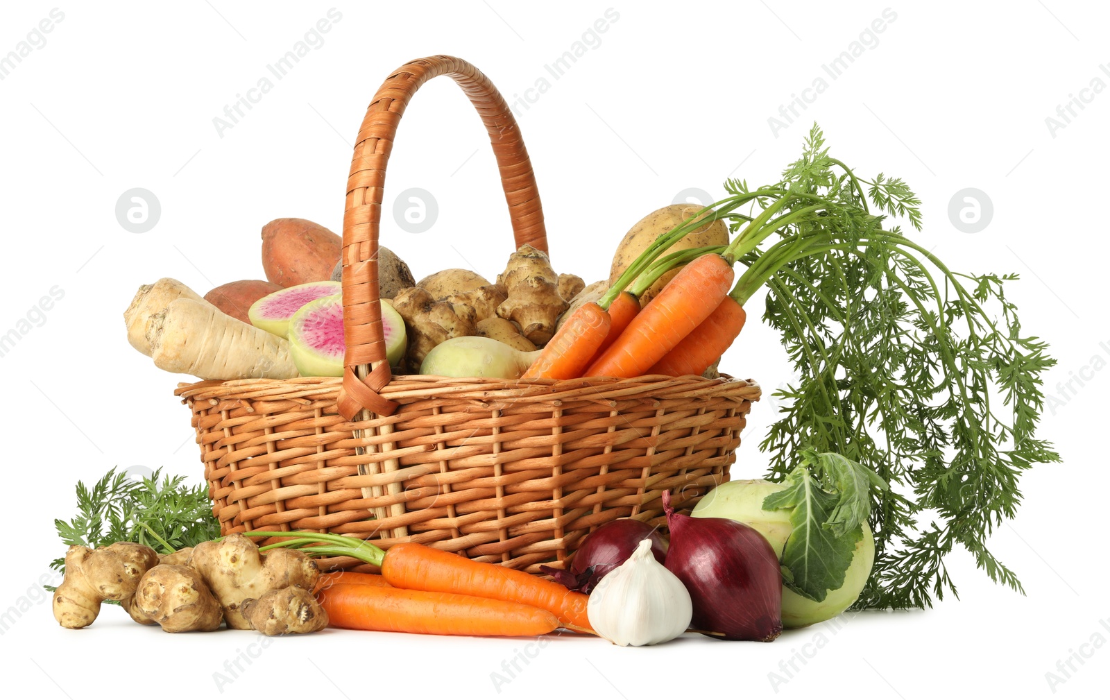 Photo of Different root vegetables in wicker basket isolated on white