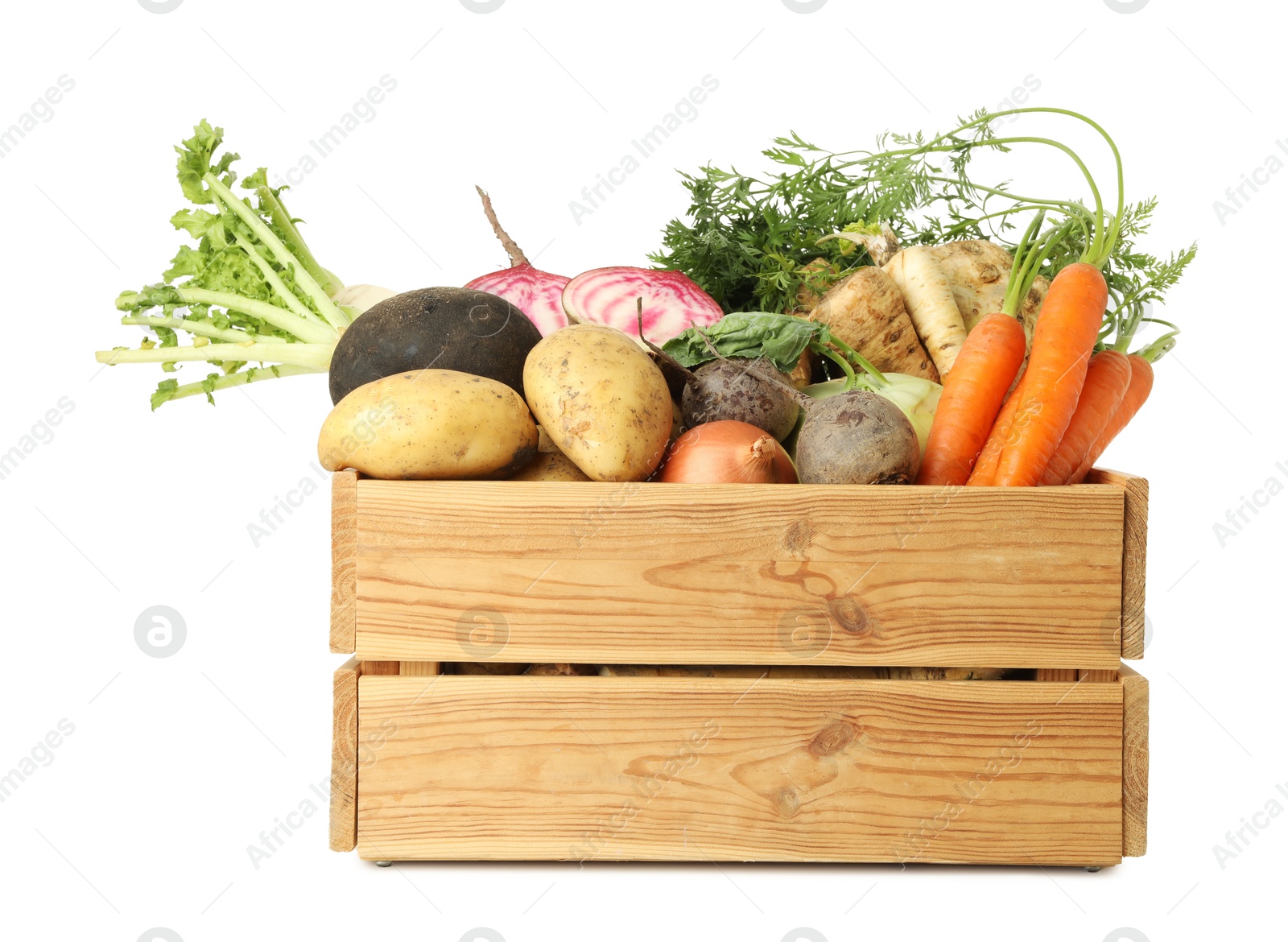 Photo of Different root vegetables in wooden crate isolated on white