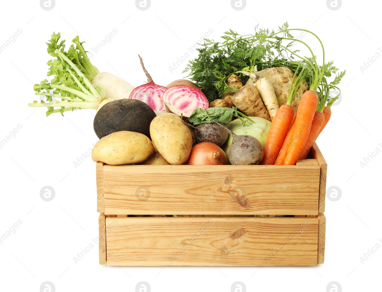 Photo of Different root vegetables in wooden crate isolated on white