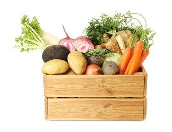 Photo of Different root vegetables in wooden crate isolated on white