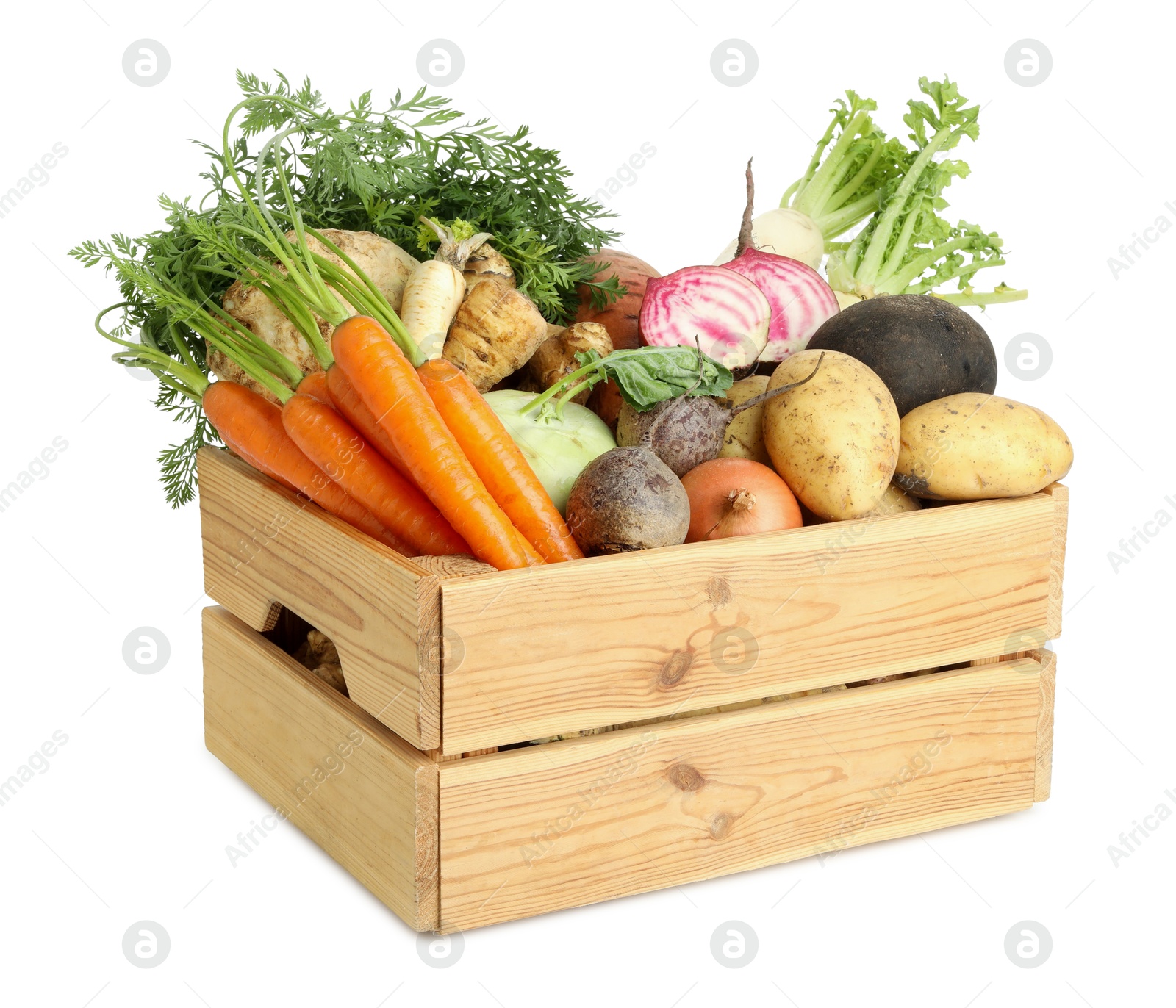 Photo of Different root vegetables in wooden crate isolated on white