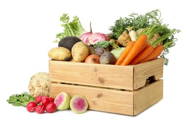 Photo of Different root vegetables in wooden crate isolated on white