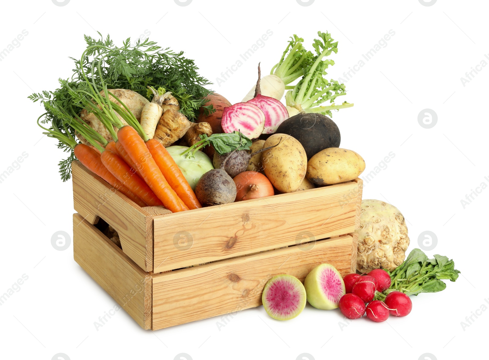 Photo of Different root vegetables in wooden crate isolated on white