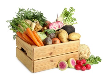 Photo of Different root vegetables in wooden crate isolated on white