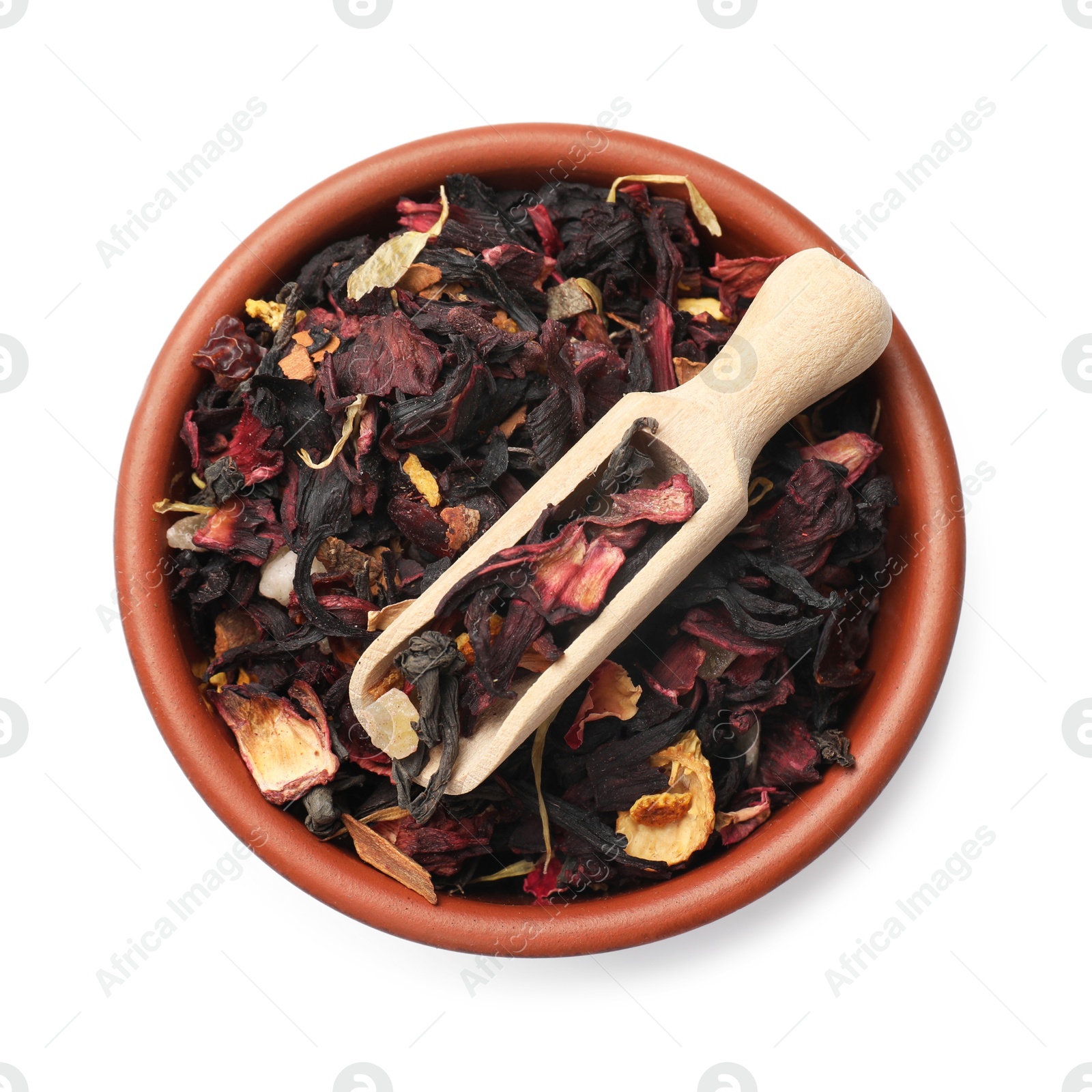 Photo of Dried tea leaves and scoop in bowl isolated on white, top view