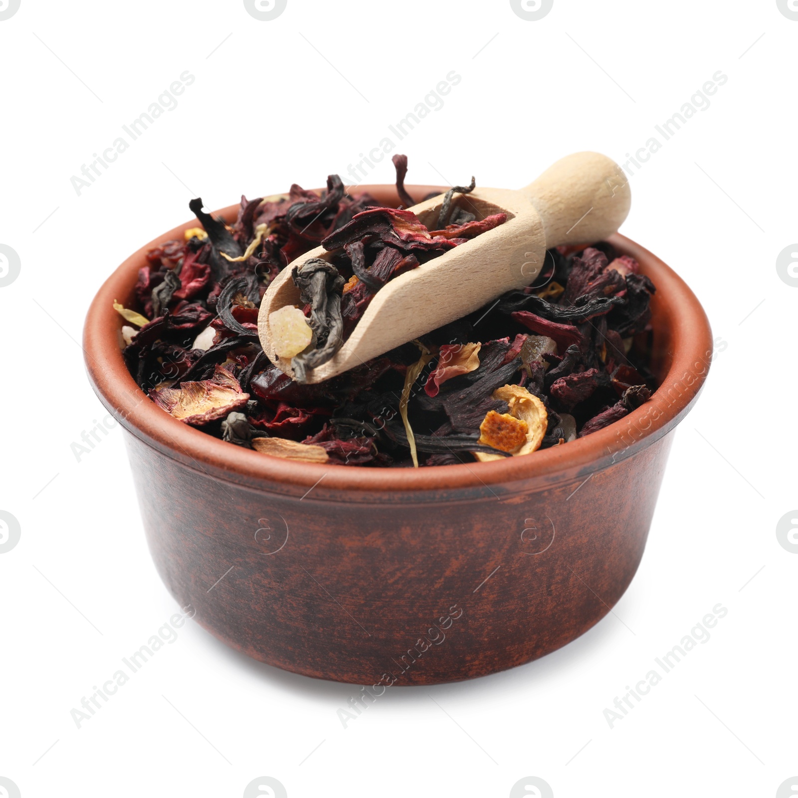 Photo of Dried tea leaves and scoop in bowl isolated on white