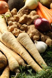 Photo of Different raw root vegetables as background, closeup