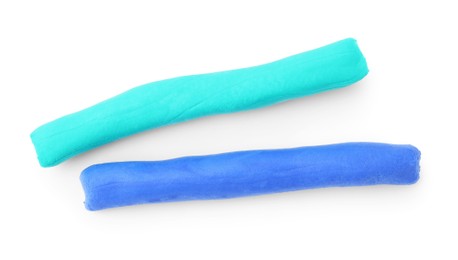 Photo of Turquoise and blue play dough on white background, top view