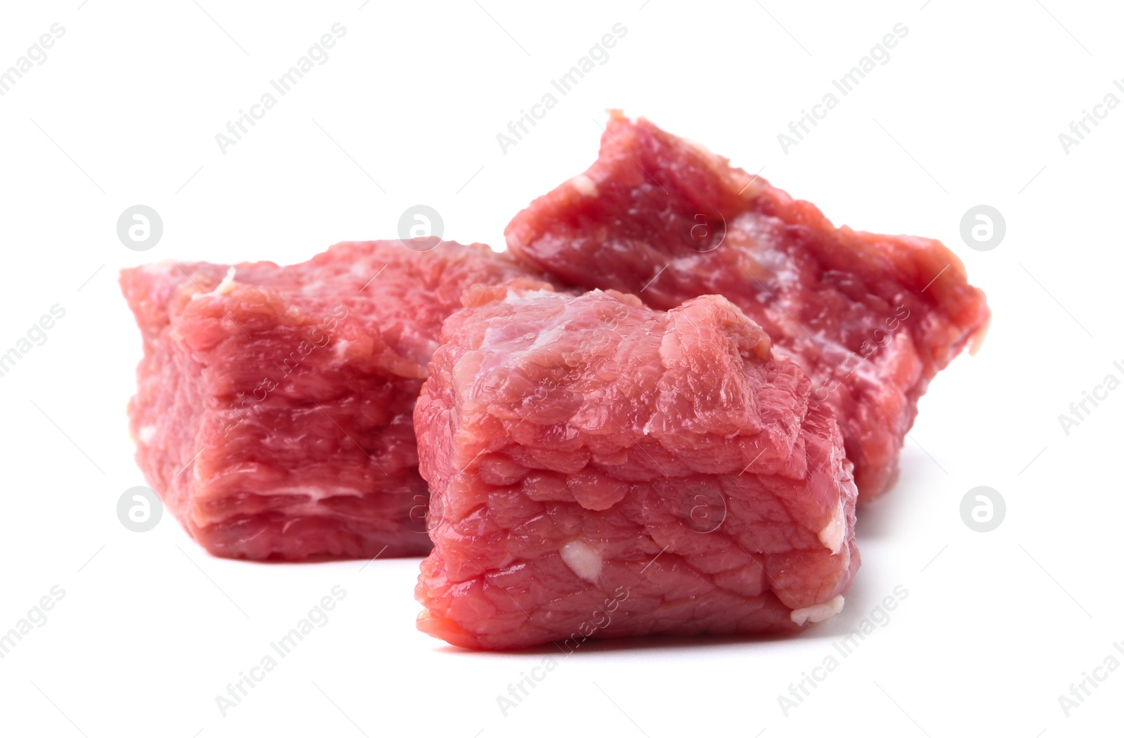 Photo of Pieces of raw beef meat isolated on white