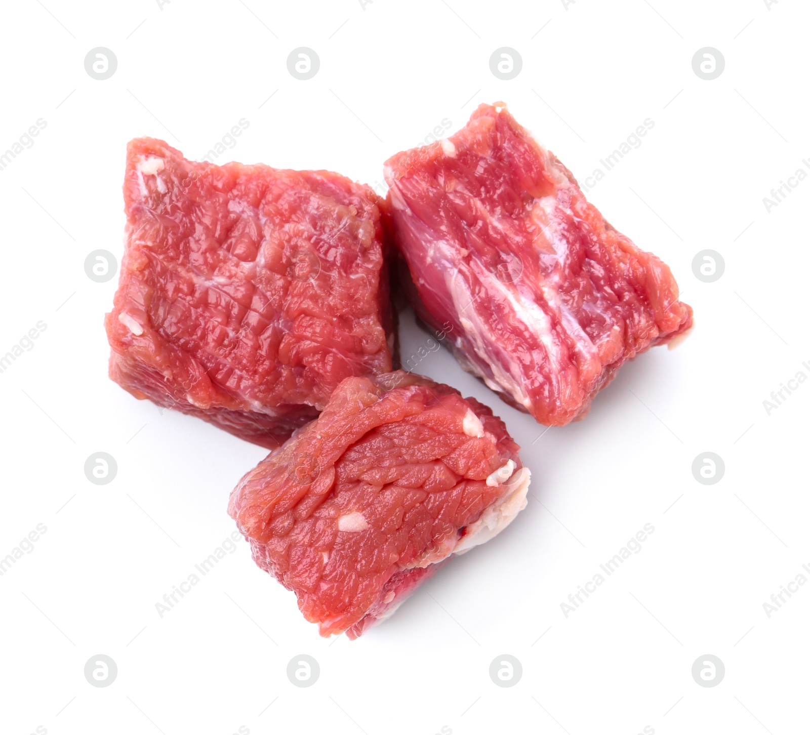 Photo of Pieces of raw beef meat isolated on white, top view