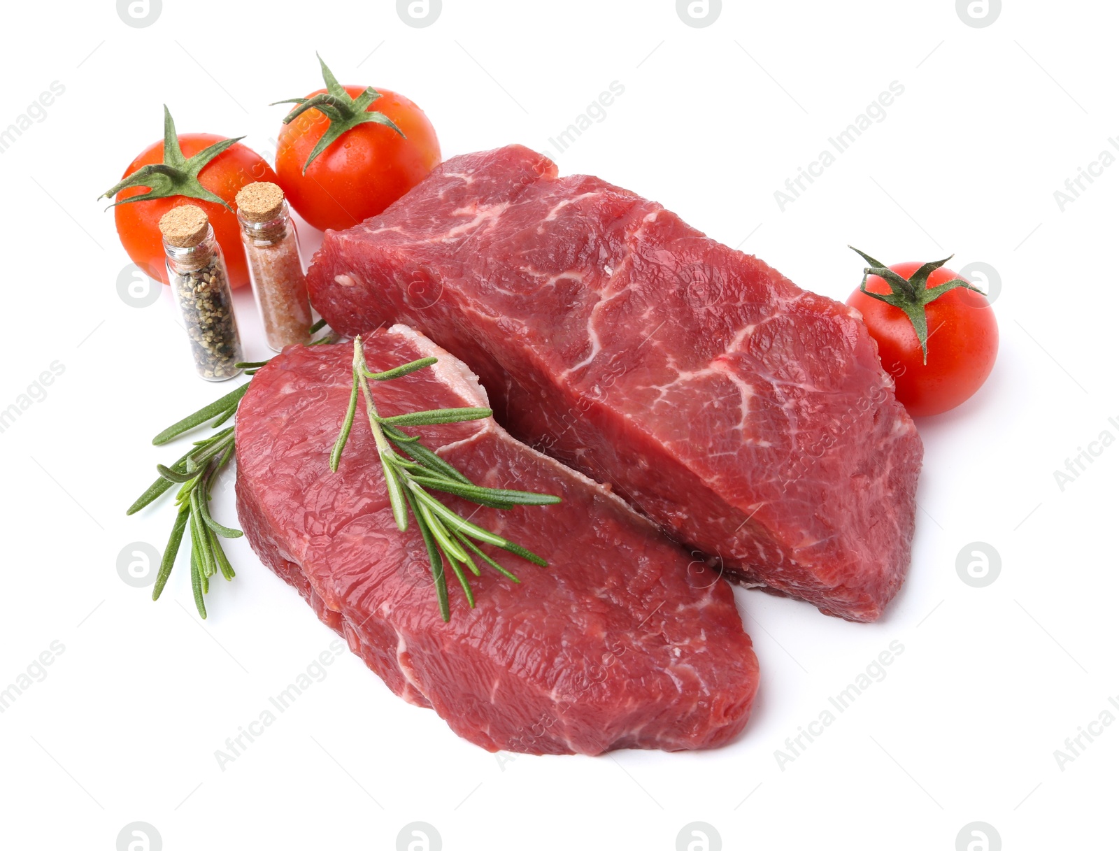 Photo of Pieces of raw beef meat, spices and tomatoes isolated on white