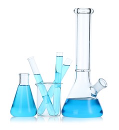 Photo of Laboratory glassware with blue liquid isolated on white