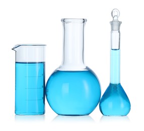 Photo of Laboratory glassware with blue liquid isolated on white