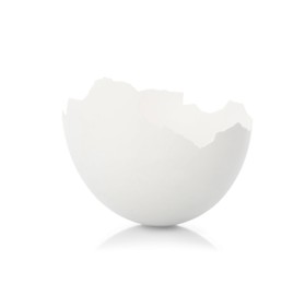 Photo of One piece of broken eggshell on mirror surface against white background