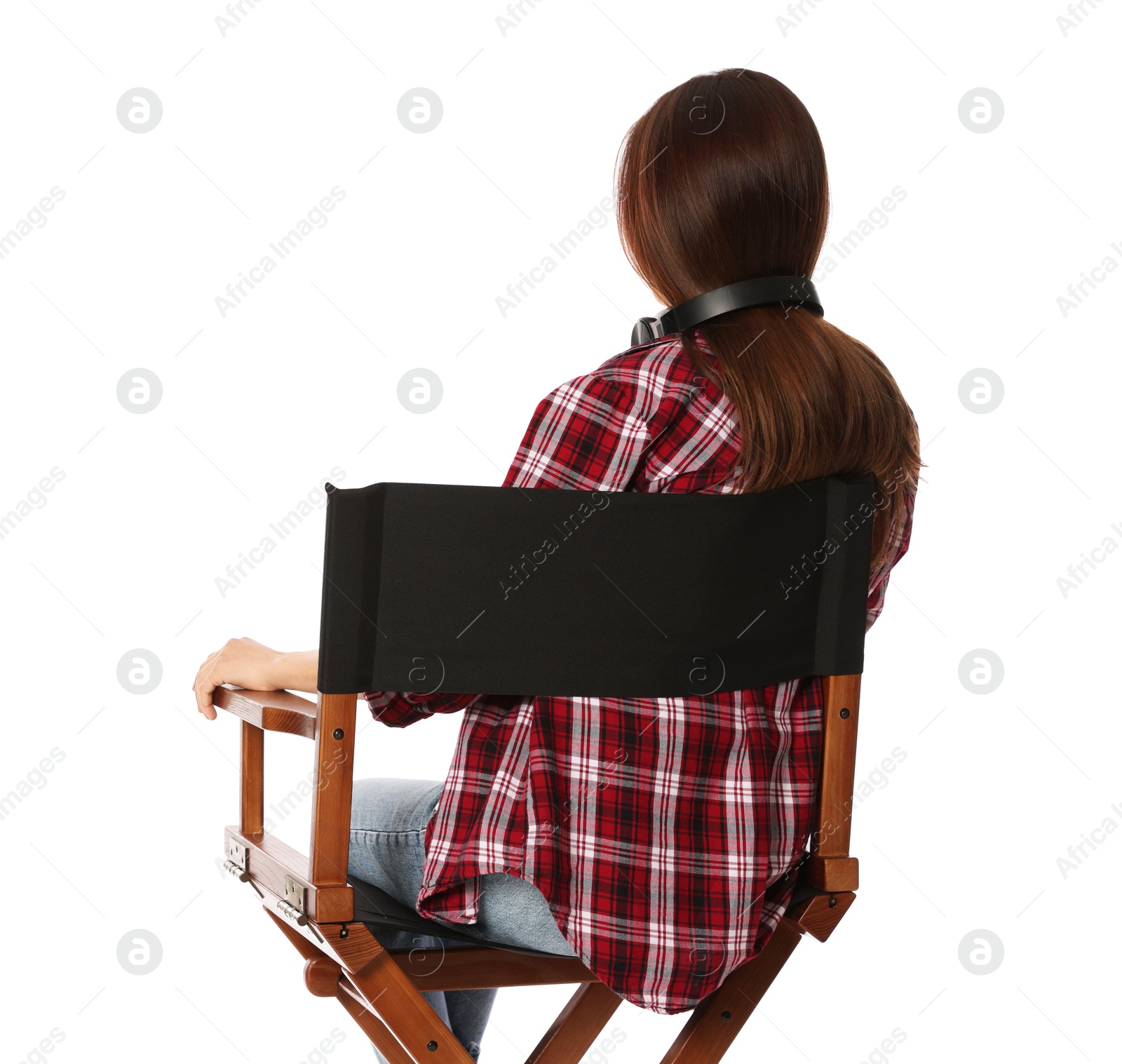 Photo of Woman sitting in director's chair on white background, back view