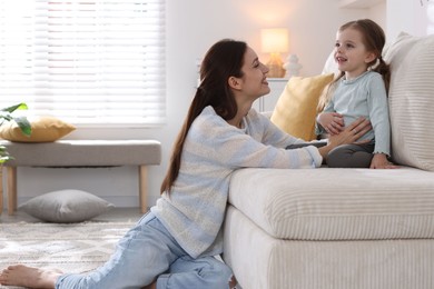 Photo of Happy mother with her cute little daughter at home