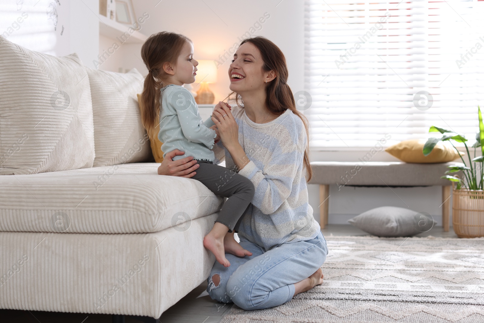 Photo of Happy mother with her cute little daughter at home