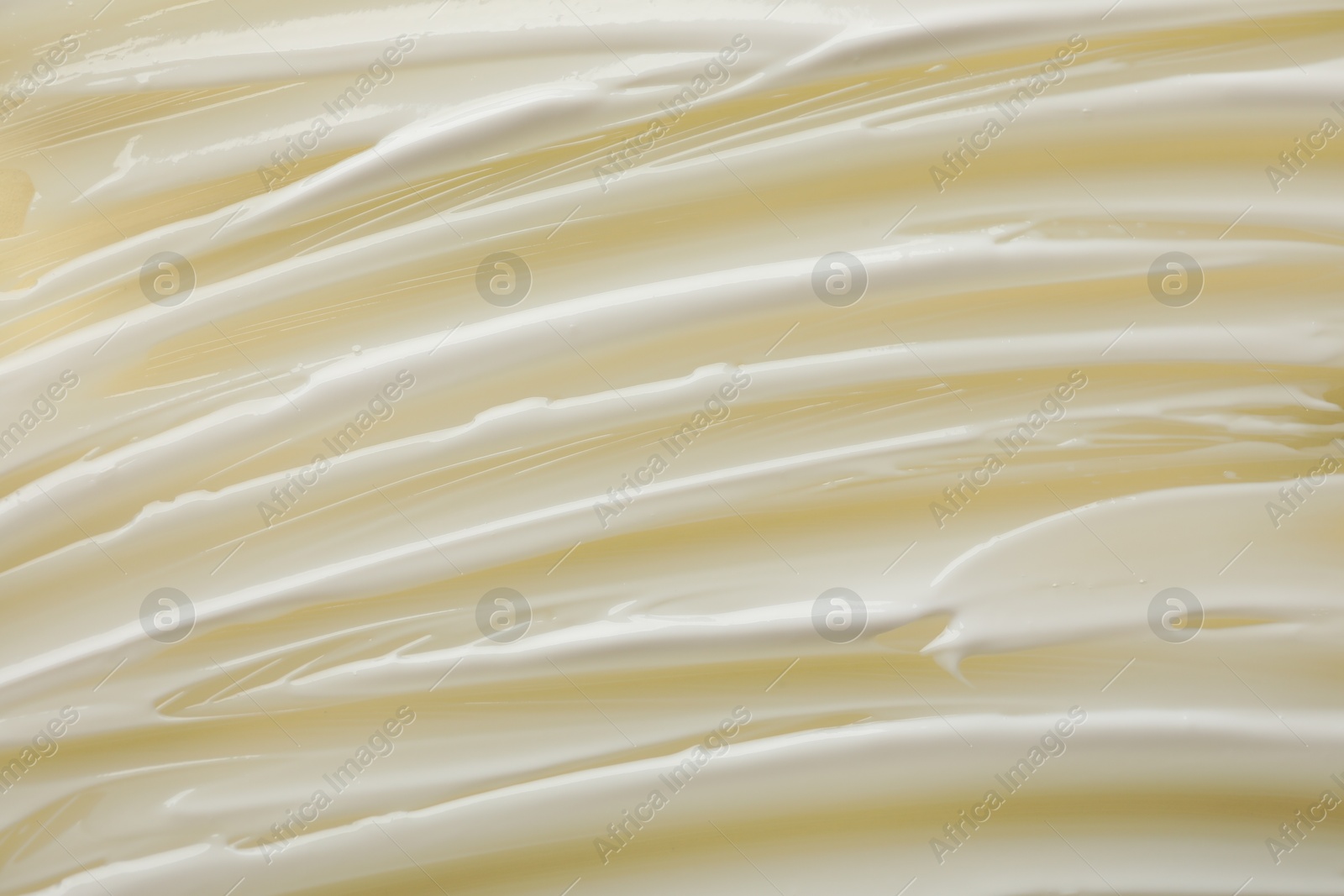 Photo of Sample of body cream on beige background, top view