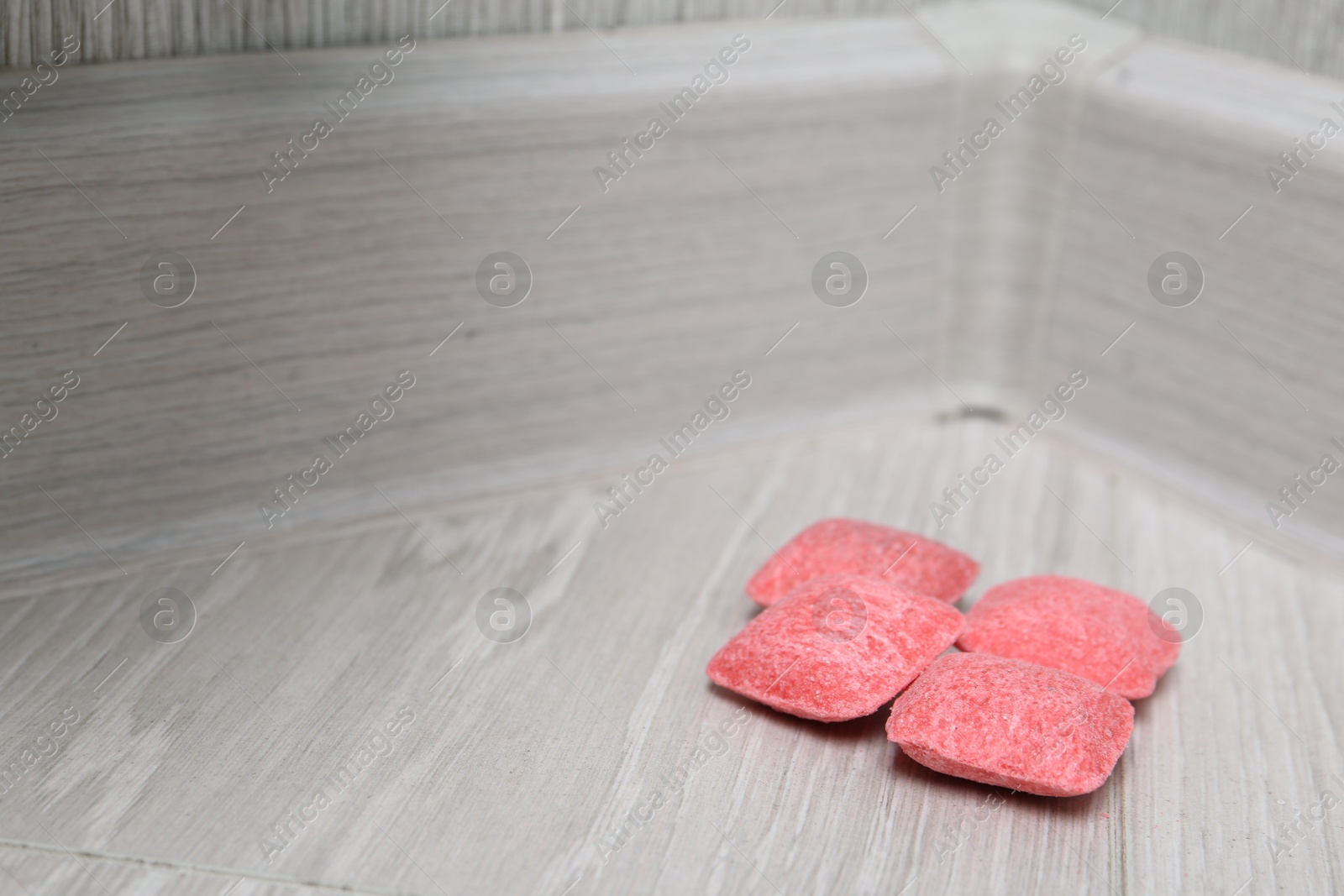 Photo of Rat poison on floor indoors, closeup. Space for text