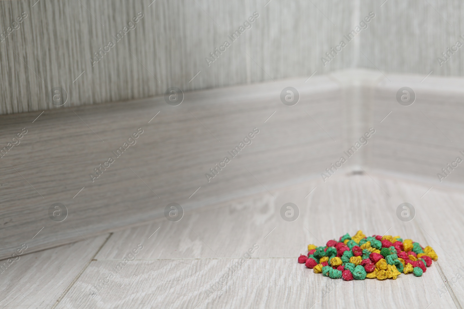 Photo of Pile of rat poison on floor indoors, space for text