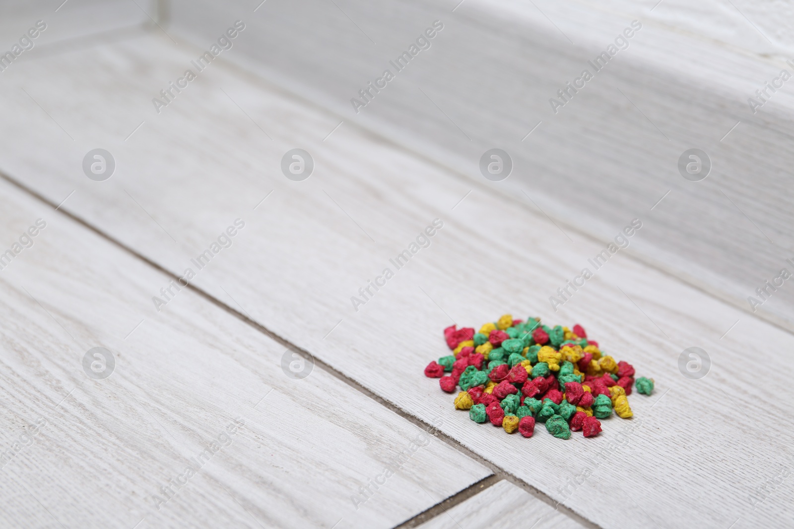 Photo of Pile of rat poison on floor indoors, space for text