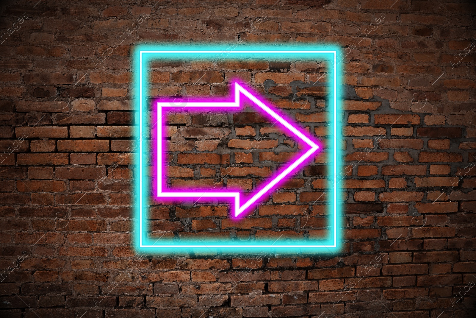 Image of Neon pointer with arrow on brick wall