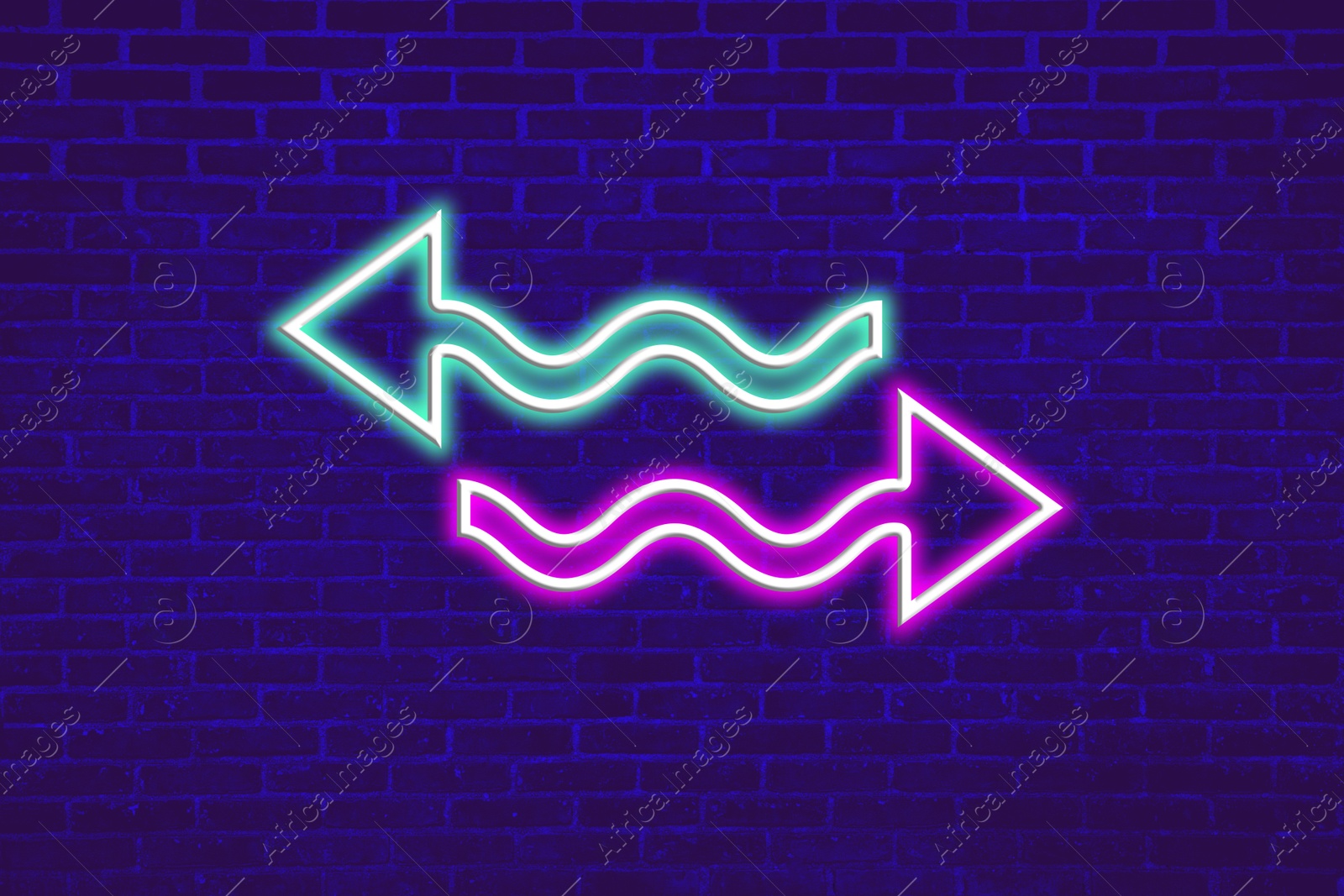 Image of Bright neon arrow-shaped pointers on blue brick wall