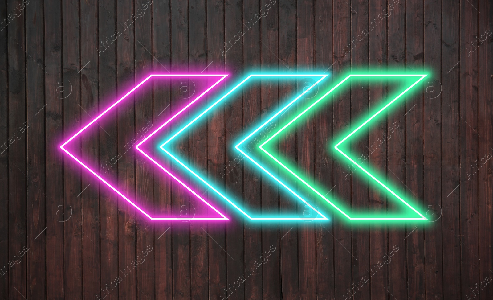 Image of Bright neon arrow-shaped pointer on wooden wall