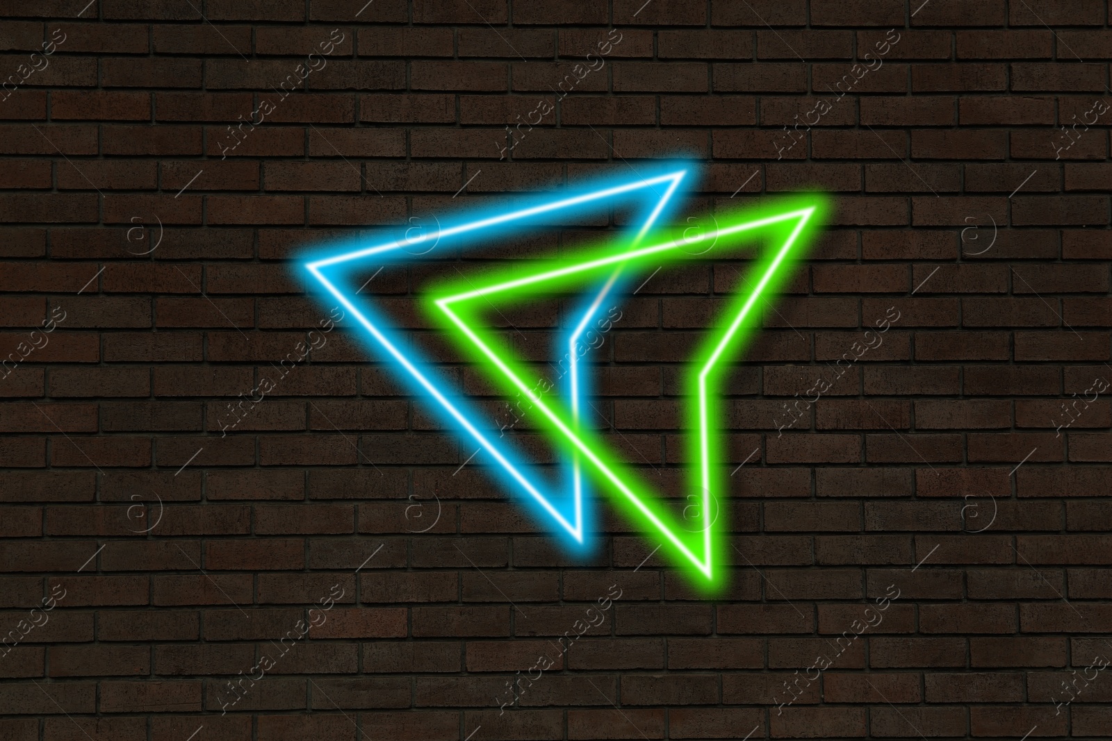 Image of Bright neon arrow-shaped pointer on brick wall