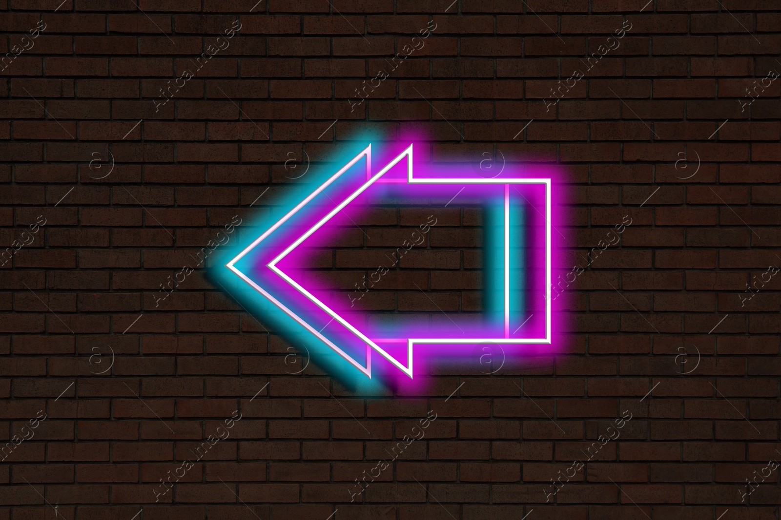 Image of Bright neon arrow-shaped pointer on brick wall