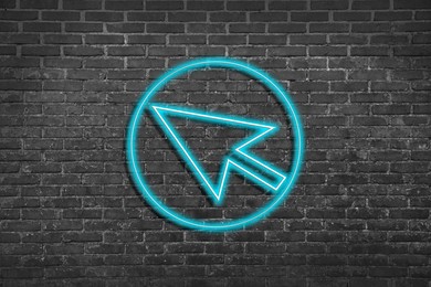 Image of Neon pointer with arrow on grey brick wall