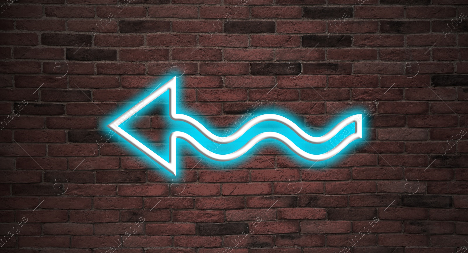 Image of Bright neon arrow-shaped pointer on brick wall