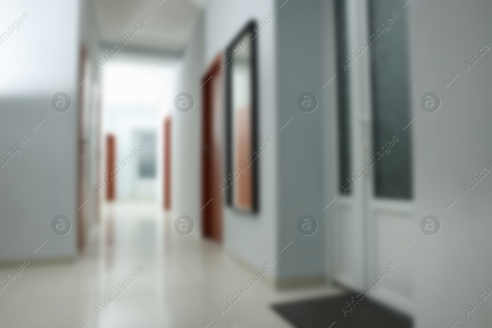 Image of Blurred view of empty office corridor with white walls