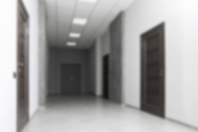 Image of Blurred view of empty office corridor with white walls