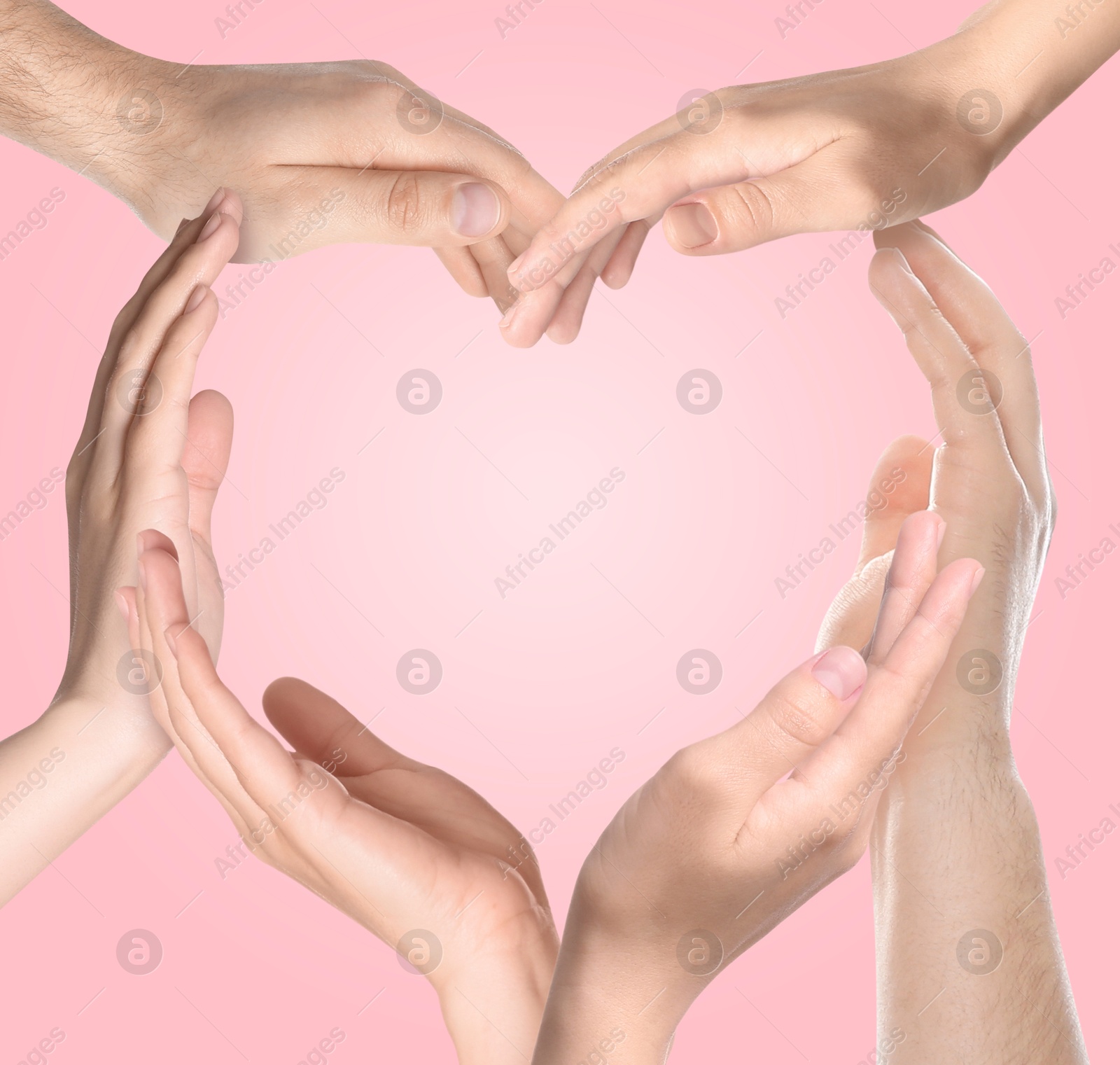 Image of Heart shape made with hands of different people on pink background. Teamwork, unity, togetherness